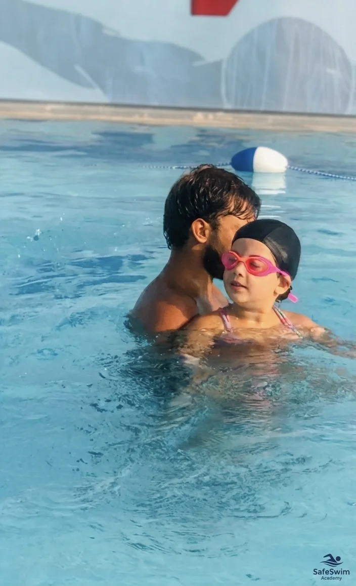 SafeSwim coach helping a young child during a swimming lesson