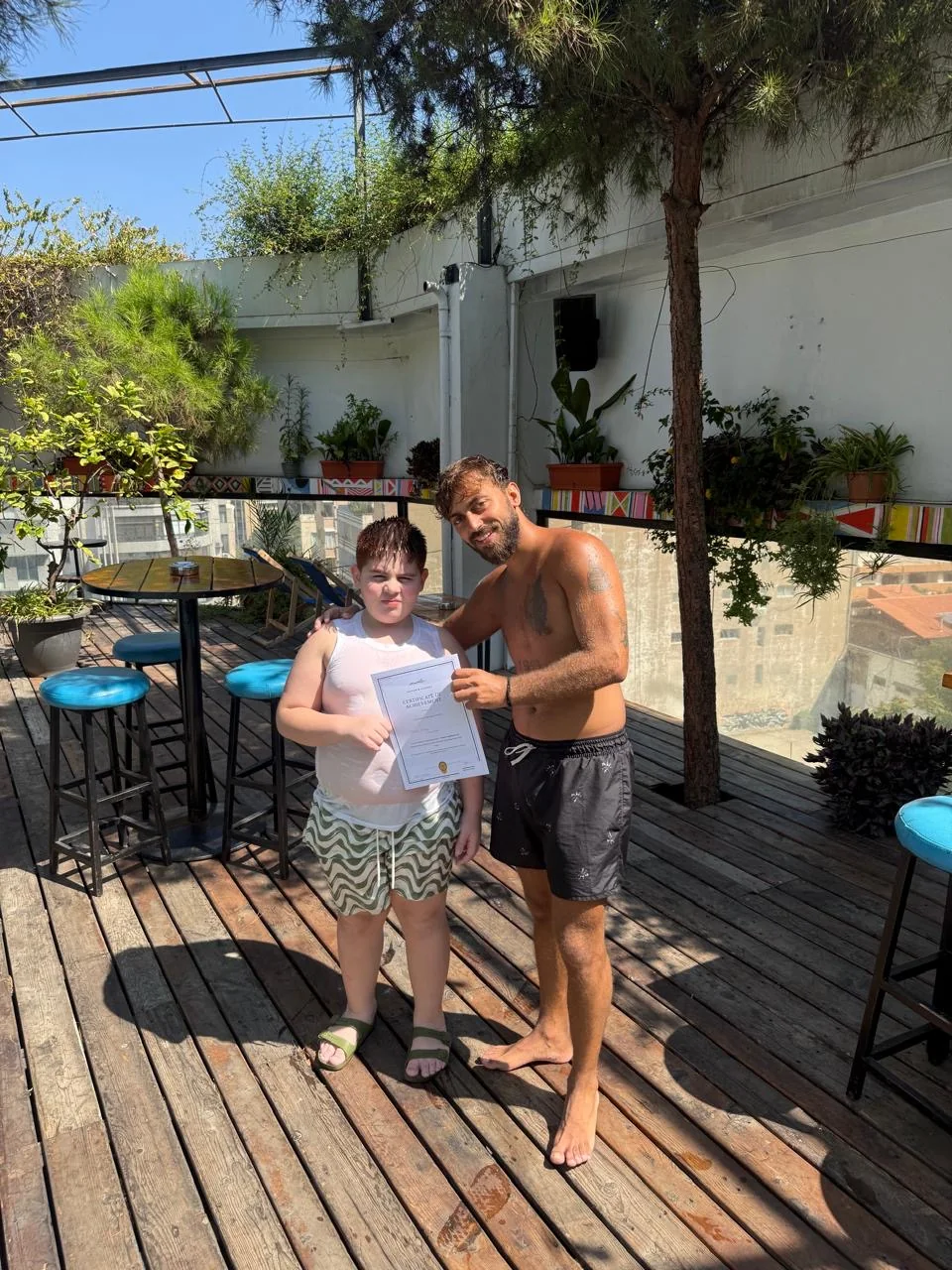 SafeSwim swimmer and coach with a certificate